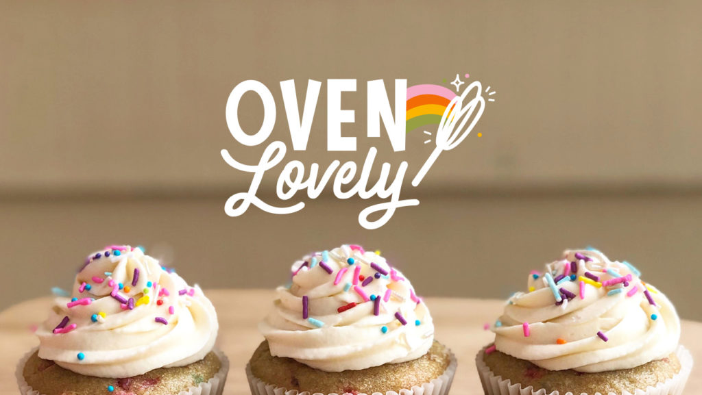 Oven Lovely logo, whisk making a rainbow on top of photograph of cupcakes